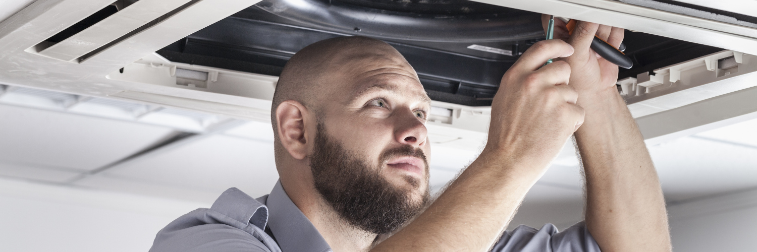 Engineer performs an air conditioning service