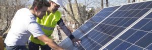 Solar installer talking to customer about installed solar panels on roof