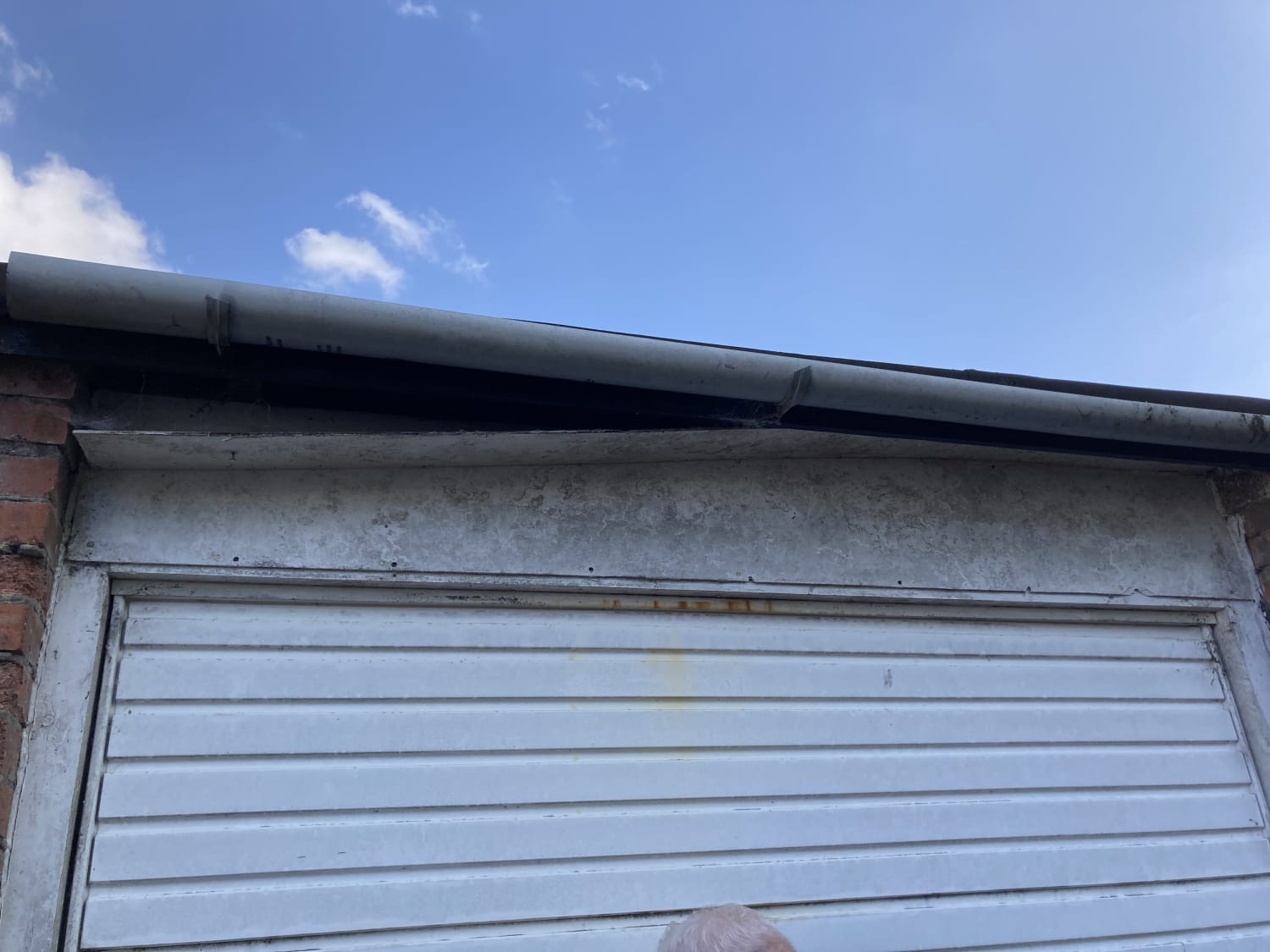 Panel removal above garage roof suspected to contain asbestos in Renfrew