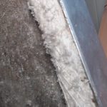 Removing ACM asbestos behind a fireplace in a Barry bungalow