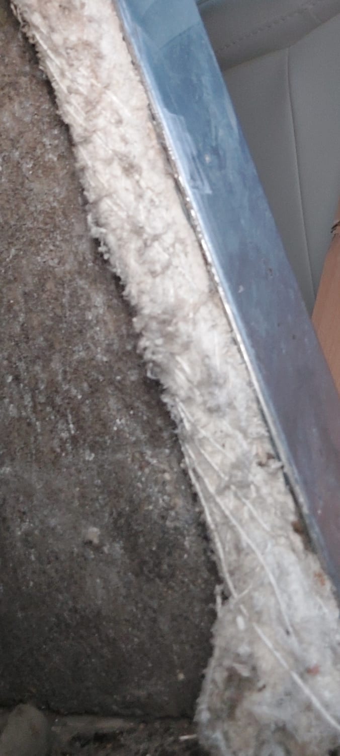 Removing ACM asbestos behind a fireplace in a Barry bungalow