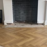 Addressing damp on concrete floor around fireplace in Liverpool