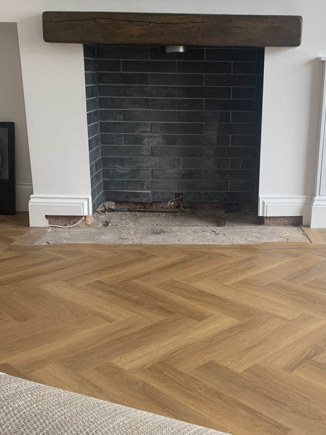 Addressing damp on concrete floor around fireplace in Liverpool