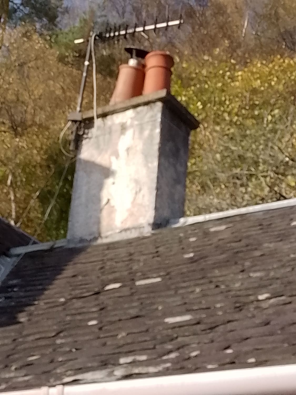 Resetting a leaning ceramic chimney pot on a slate roof in Inverness