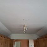 Safe removal of asbestos ceiling board in a kitchen in Wirral