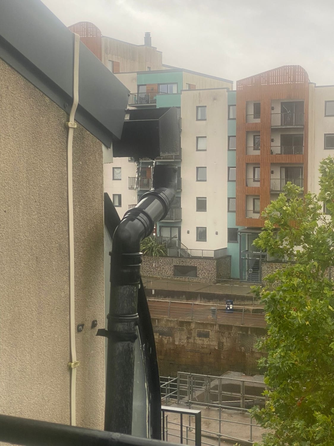 Downpipe and bracket repair on a three storey building in Bristol