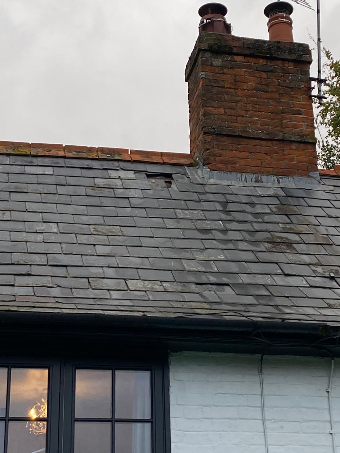 Fixing displaced natural slate tiles near chimney in Pewsey