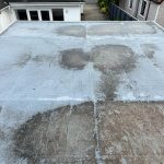 Water ingress in garage flat roof with standing water in Glasgow