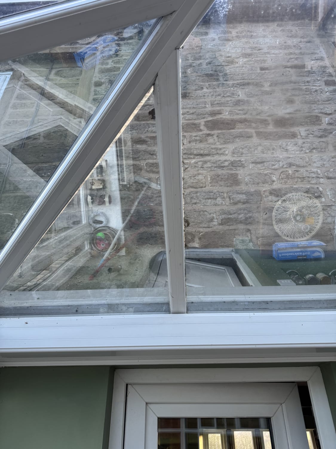 Conservatory roof pane realignment and cleaning in Oldham